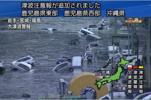 ...die Tsunami-Wellen überrollen weiterhin das Land. Dieses Foto zeigt im Wasser schwimmende Autos im Gebiet der Präfektur Miyagi...