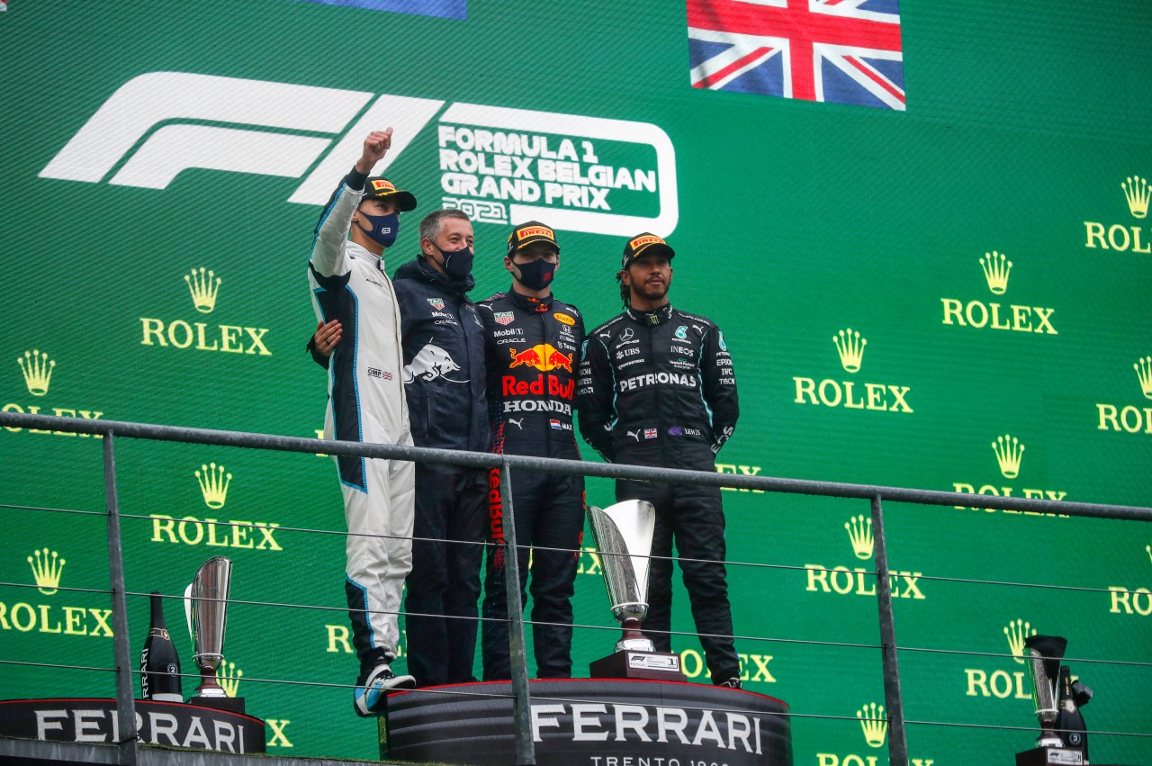 George Russell (l.) gemeinsam mit Max Verstappen (2. v.r.) und Lewis Hamilton (r.) auf dem Belgien-Podium.
