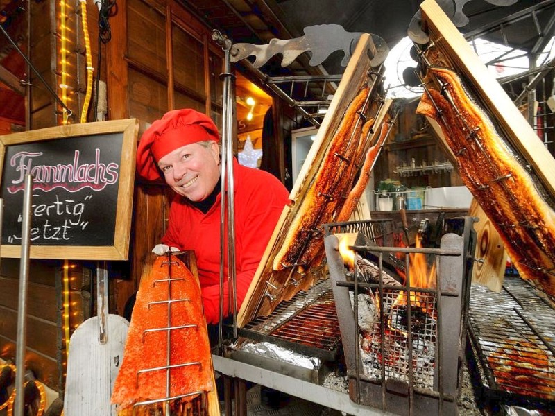 Am Freitag, den 18.11.2011 steht Mario Traber an seinem Stand auf dem Weihnachtsmarkt in Duisburg - Mitte. Dort verkauft er zum ersten Mal seinen Flammlachs . Der frische Lachs aus Finnland wird dabei über einem Holzfeuer nach alter finnischer Tradition gegart Foto: Stephan Eickershoff / WAZ FotoPool