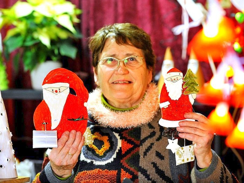 Am Samstag, den 19.11.2011 strömen tausende Besucher am ersten Wochenende auf den Weihnachtsmarkt in Duisburg - Mitte. Bei trockenem kühlen Wetter geniessen die Leute Glühwein , Leckereien oder kaufen schon mal das ein oder andere Geschenk für Weihnachten. Im Foto : Die 79-jährige Duisburgerin Anne Breithecker verkauft selbstgebastelten WeihnachtsschmuckFoto: Stephan Eickershoff / WAZ FotoPool