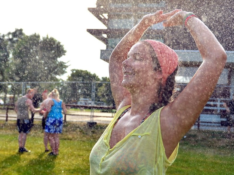 Hannah genießt auf dem Greenville-Festival eine Dusche unter dem Rasensprenger.