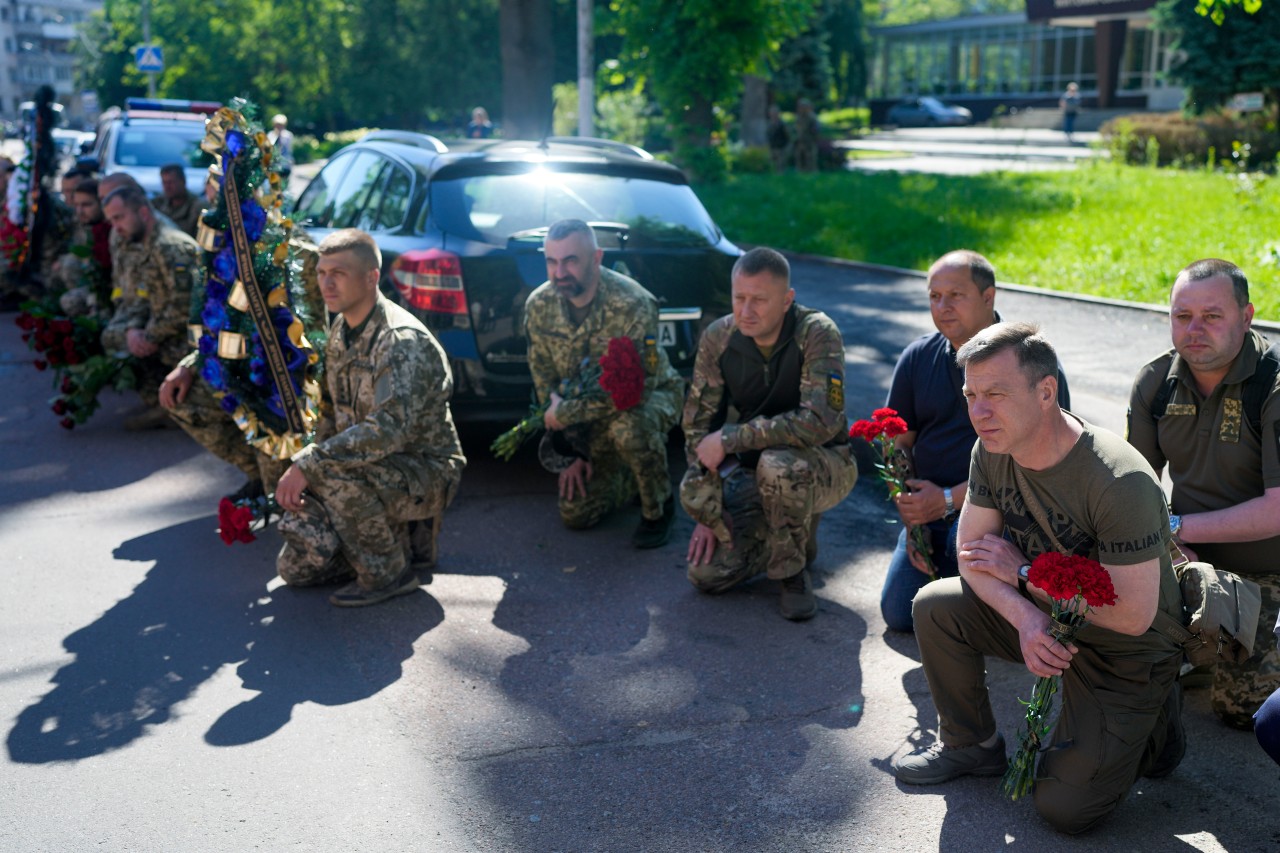 03.06.2022, Ukraine, Schytomyr: Ukrainische Soldaten knien während der Trauerfeier für Oberst O. Makhachek nieder. Nach Angaben von Kampfgefährten wurde Makhachek im Kampf gegen russische Truppen getötet, als am 30.05.2022 eine Granate in seiner Stellung einschlug. 