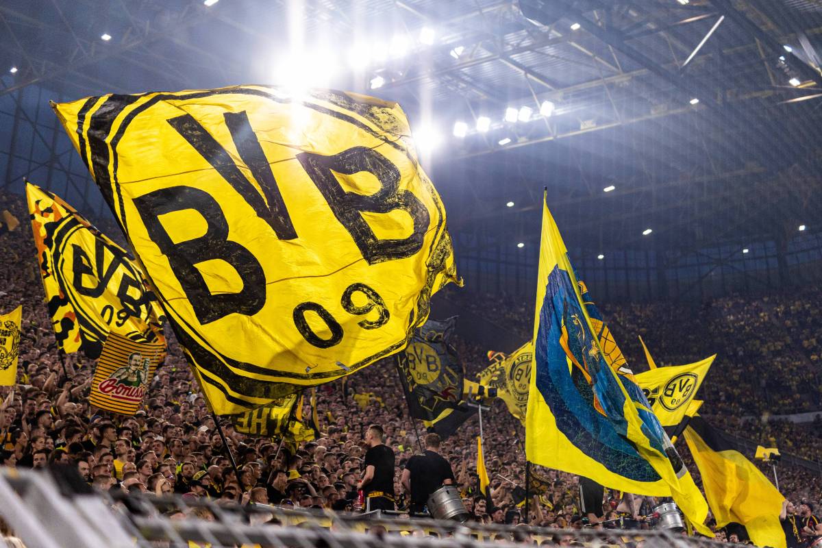 Fans von Borussia Dortmund schwenken Fahnen auf der Südtribüne.