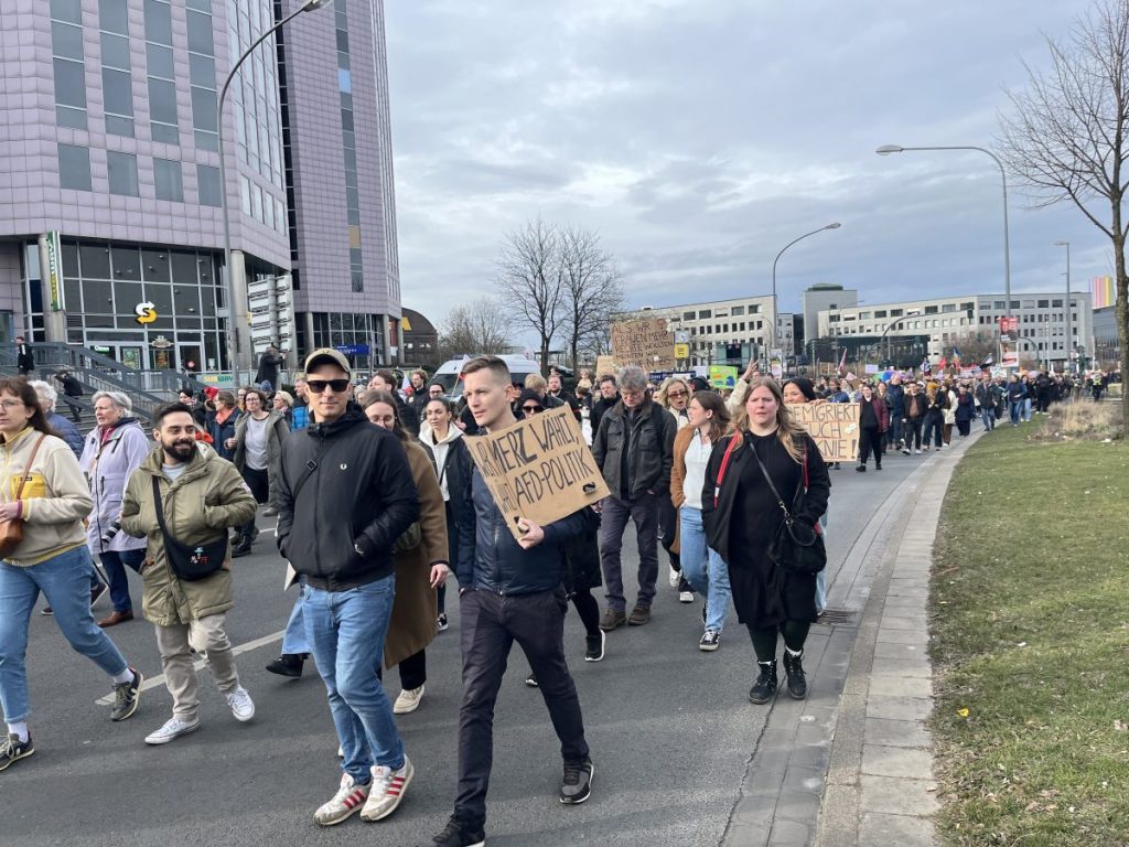 Demonstranten mit Merz-Plakaten in Essen